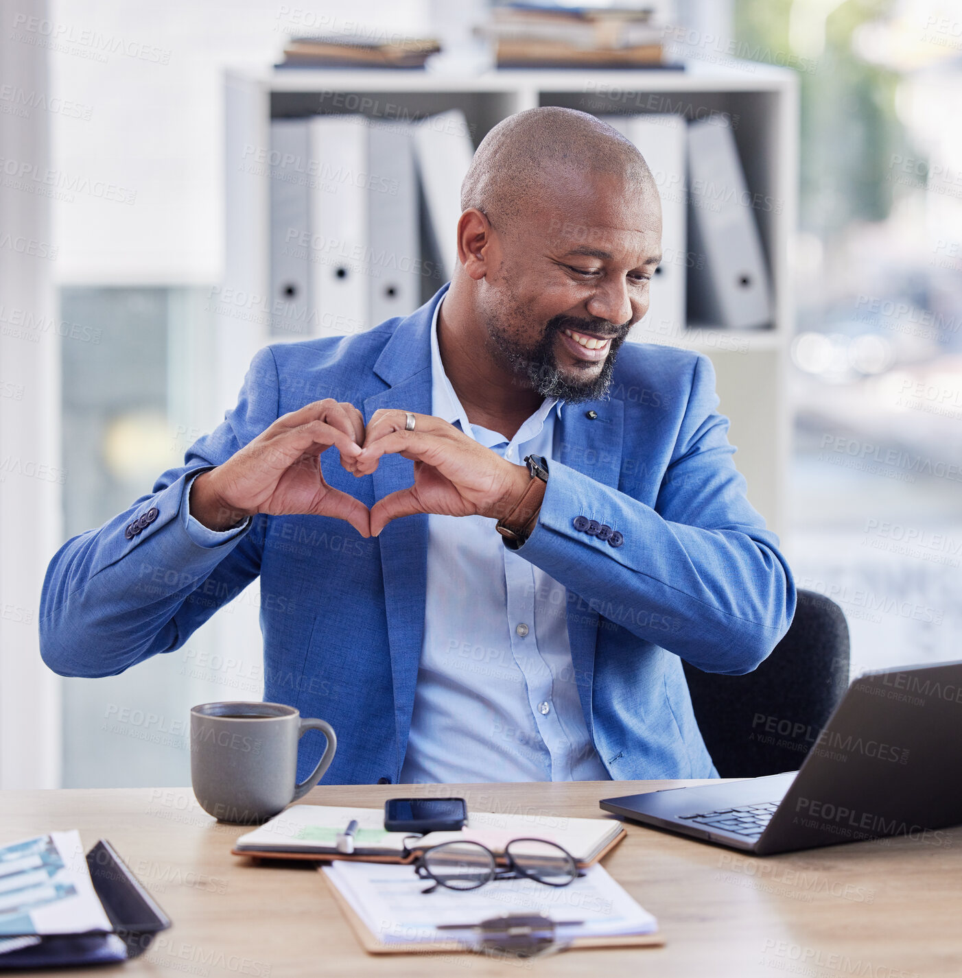 Buy stock photo Business, hands in heart and black man in office with laptop, notebook and coffee at corporate workplace. Success, leadership and male entrepreneur with hand sign for thank you, support and community
