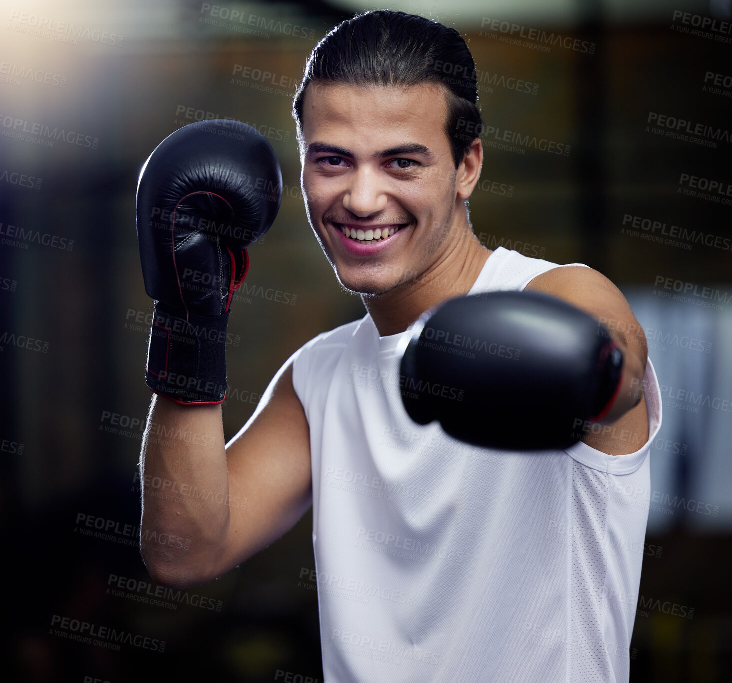 Buy stock photo Portrait, fitness and boxing man punching with boxing gloves in a sport gym for health. Athlete, boxer and face of strong male personal trainer prepare for a fight or kickboxing and muay thai event