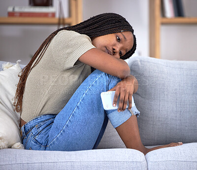 Buy stock photo Breakup depression, sad and thinking black woman with a phone after communication, problem and anxiety about email on the couch. Mental health, idea and African girl depressed about chat fail