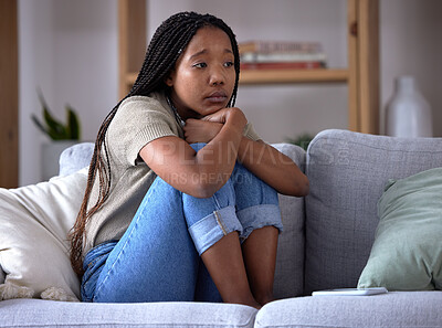 Sad, depression and lonely black woman on sofa with mental health issue, problems and stress. Thinking, reflection and depressed girl sitting in living room with mistake, failure and negative emotion
