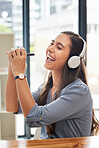 Woman, singing and listening to music with smile for streaming, entertainment and headphones at the office. Happy female smiling for audio track, sing and sound for fun, hifi and chilling at work
