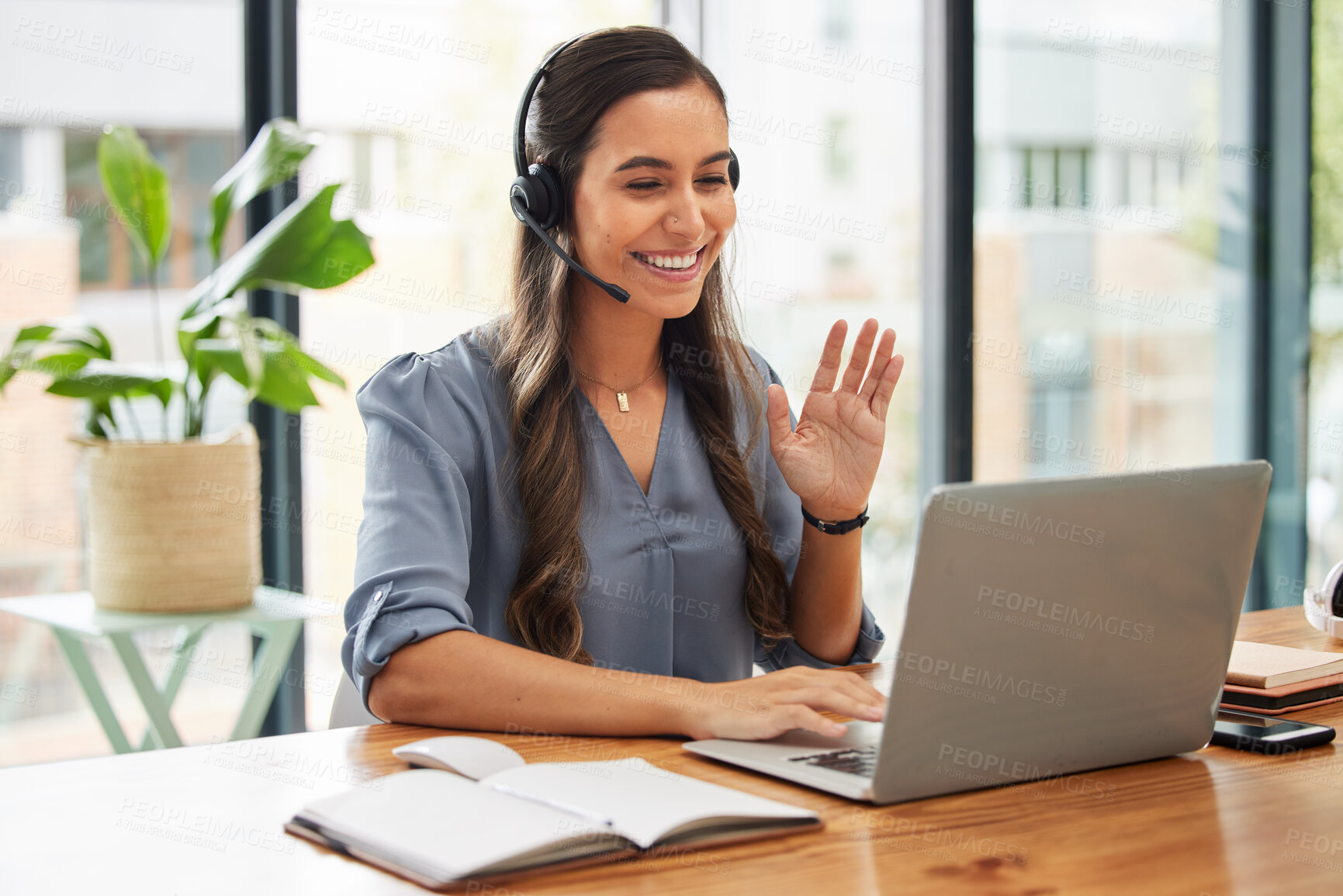 Buy stock photo Video call, business woman and wave on laptop with headphones for communication, virtual meeting and global consulting in startup company. Happy female worker, smile and hello on computer conference 