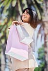 Bags, shopping and portrait of a woman in the city for a luxury retail sale, promotion or discount. Happy, smile and rich fancy housewife buying fashion clothes in an urban town in Puerto Rico. 