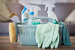 Cleaning, products and basket on table in home living room for spring cleaning. Hygiene, cleaning supplies and housekeeping equipment for disinfecting, sanitizing or removing germs, bacteria or dust.