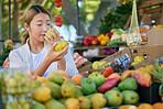 Fruits, food and woman in Japan market for quality choice, nutrition and healthy shopping in green, eco friendly store. Outdoor marketplace, pear and vegan asian or customer sale, offer and discount