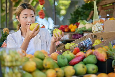 Buy stock photo Grocery shopping, Asian woman and fruit choice at outdoor market. Food, fruits and female smelling and choosing healthy, delicious and fresh pears for health, wellness and vitamin c at store or shop.