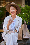 Shopping, city and woman in Japan with smartphone for ecommerce website, fintech and internet deal on sales, product promotion and discount. Cellphone, asian or Japanese girl and shopping bag at mall
