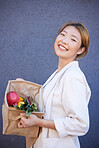 Woman, face or grocery basket with organic fruit, healthy food or Japanese diet produce on blue background with mockup advertising space. Portrait, smile or happy customer with supermarket vegetables