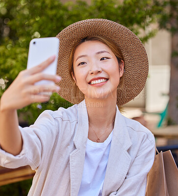 Buy stock photo Selfie, smartphone and shopping bag of woman in city or park for social media post, profile picture update and fashion blog in Japan. Cellphone photography, happy woman or influencer with retail tips
