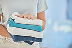 Clean towels, hands and woman with laundry, linen and cotton textile in stack with mockup. Closeup cleaner, maid and fabric towel for spring cleaning services, hospitality and hotel room maintenance 