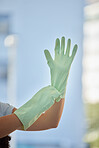 Woman, hands and gloves for cleaning home, hygiene and wellness. Spring cleaning, housekeeper or female cleaner getting ready for cleaning service to disinfect house to remove bacteria, germs or dust