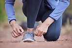 Start, running and feet of a woman in nature, training motivation and cardio fitness in Colombia. Ready, shoes and hands of an athlete tying laces for workout, exercise or hiking in a park for health