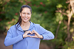 Cardiovascular, woman with hands in heart shape and fitness with health, running for cardio and exercise outdoor with portrait. Cardiology, runner and sport, run and mockup with cholesterol balance.