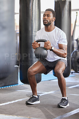 Buy stock photo Black man, gym and kettlebell for squat exercise, weightlifting workout or muscle growth training. African bodybuilder, wellness trainer and metal weights for strong legs, body development or health