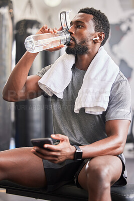 Buy stock photo Water bottle, black man in gym and smartphone for social media after fitness exercise, healthy sports workout and muscle growth. Wellness work out, training motivation and a tired guy drinking water 