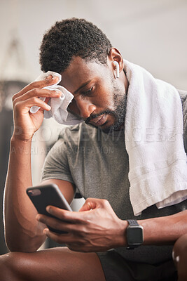 Buy stock photo Black man, phone and sweat for relax fitness or typing sports communication online, exercise training and runner workout. Cardio wellness, run motivation rest or athlete reading on smartphone in gym