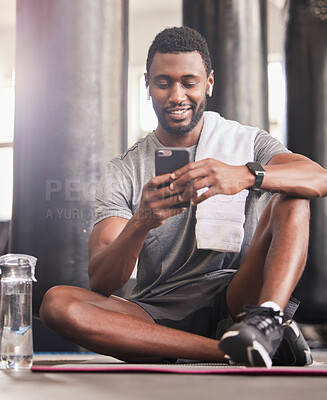 Buy stock photo Fitness, phone and black man relax and smile for online communication, sports workout or watching exercise tutorial in gym. Happiness, training wellness video on mobile and rest after cardio run