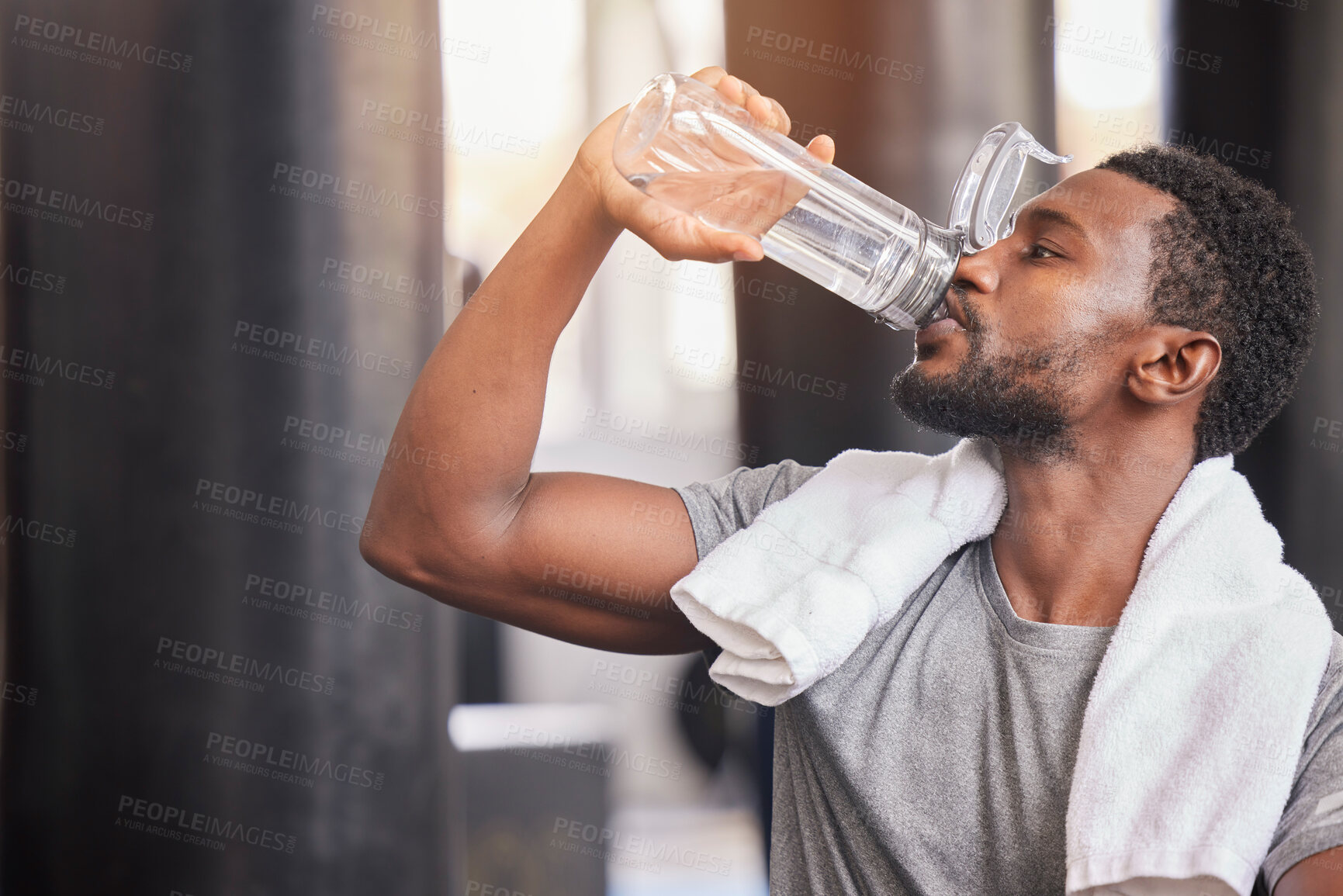 Buy stock photo Fitness, drinking water and relax with black man in gym for training, endurance and workout. Energy, focus and sweat with athlete bodybuilder cooling down in club for sports, exercise and cardio