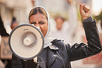 Freedom, megaphone and fist with muslim woman in protest for support, social justice and human rights activist. Politics, revolution and equality with hijab girl in crowd for discrimination fight