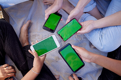 Buy stock photo Top view, hands or people with green screen phones for social media app, internet esports game or music sharing software. Men, women or friends with mock up technology space on bonding beach picnic