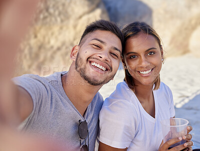 Buy stock photo Selfie, couple of friends and drinks at beach in summer, party and relax holiday for love, care or happiness. Portrait, young man and smile woman taking photo in sunshine, picnic or happy date at sea