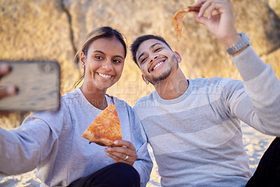 Buy stock photo Happy couple, selfie and pizza while at the beach for a picnic date together with food, phone and happiness outdoor in nature. Man and woman with smartphone and lunch while online for profile update