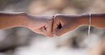 Fist bump, friends and support motivation outdoor for partnership travel holiday or trust vacation. Greeting, friendship agreement and celebrate collaboration success or hands together for solidarity