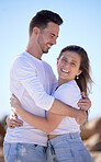 Portrait, couple love and hug at beach and happy with smile for relationship, romantic date or vacation together. Romance, man and woman with happiness, summer and embrace for travel or holiday