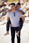 Couple, piggyback and selfie on the beach to have fun and bond with love and affection. Man, woman and ocean date while taking a mobile photo on the sea sand for romance and tropical holiday