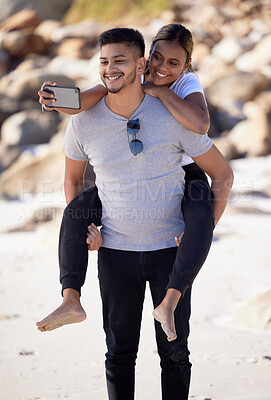 Buy stock photo Couple, piggyback and selfie on the beach to have fun and bond with love and affection. Man, woman and ocean date while taking a mobile photo on the sea sand for romance and tropical holiday