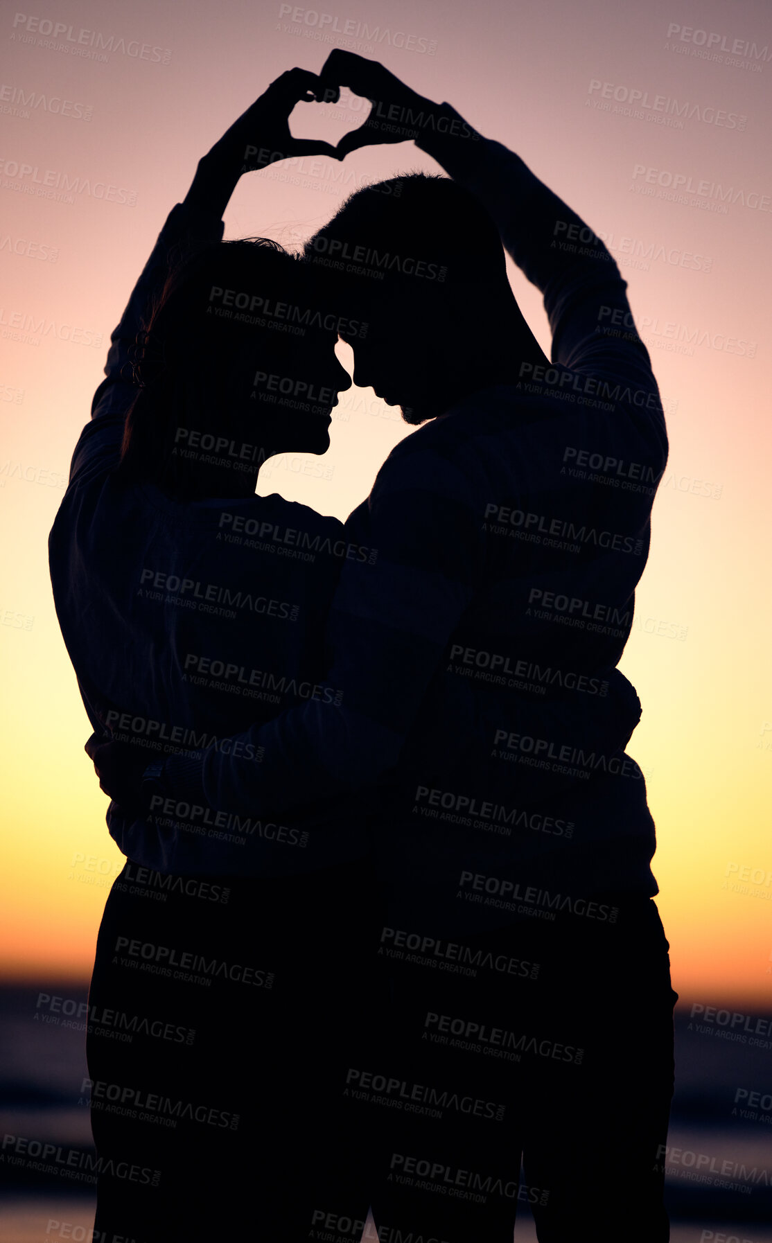 Buy stock photo Love, heart hands and couple silhouette at beach during sunset, summer care and happy on holiday in Bali. Emoji, dark and man and woman with happiness, affection and sign on honeymoon at the ocean