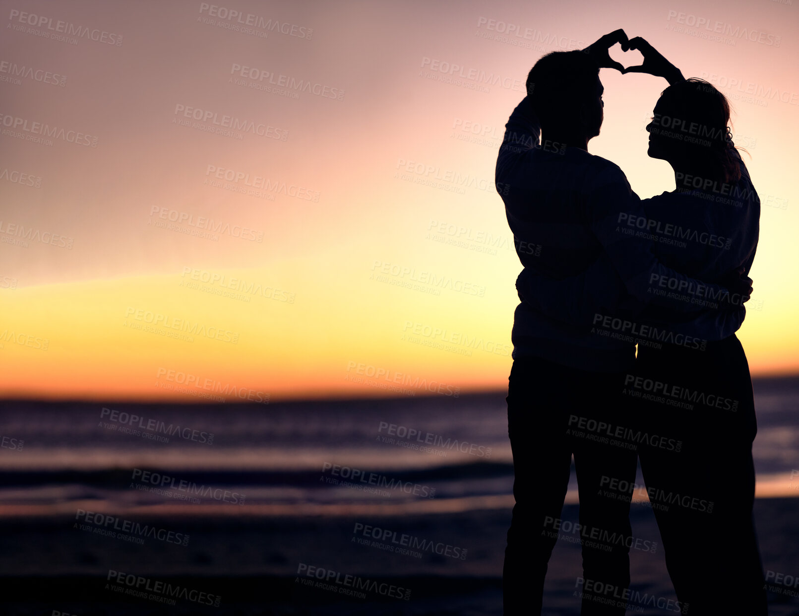 Buy stock photo Couple, silhouette and sunset beach with heart shape hands for love, commitment and care on a romantic date, holiday or honeymoon at sea. Man and woman together on ocean vacation for nature travel