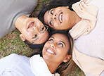 Faces, group and women lying on the ground in a park for cheerful bonding with love and care. Friendship, overhead and female hangout in a garden outdoors for bond and relationship in nature