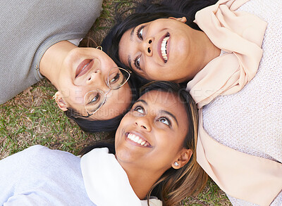 Buy stock photo Faces, group and women lying on the ground in a park for cheerful bonding with love and care. Friendship, overhead and female hangout in a garden outdoors for bond and relationship in nature