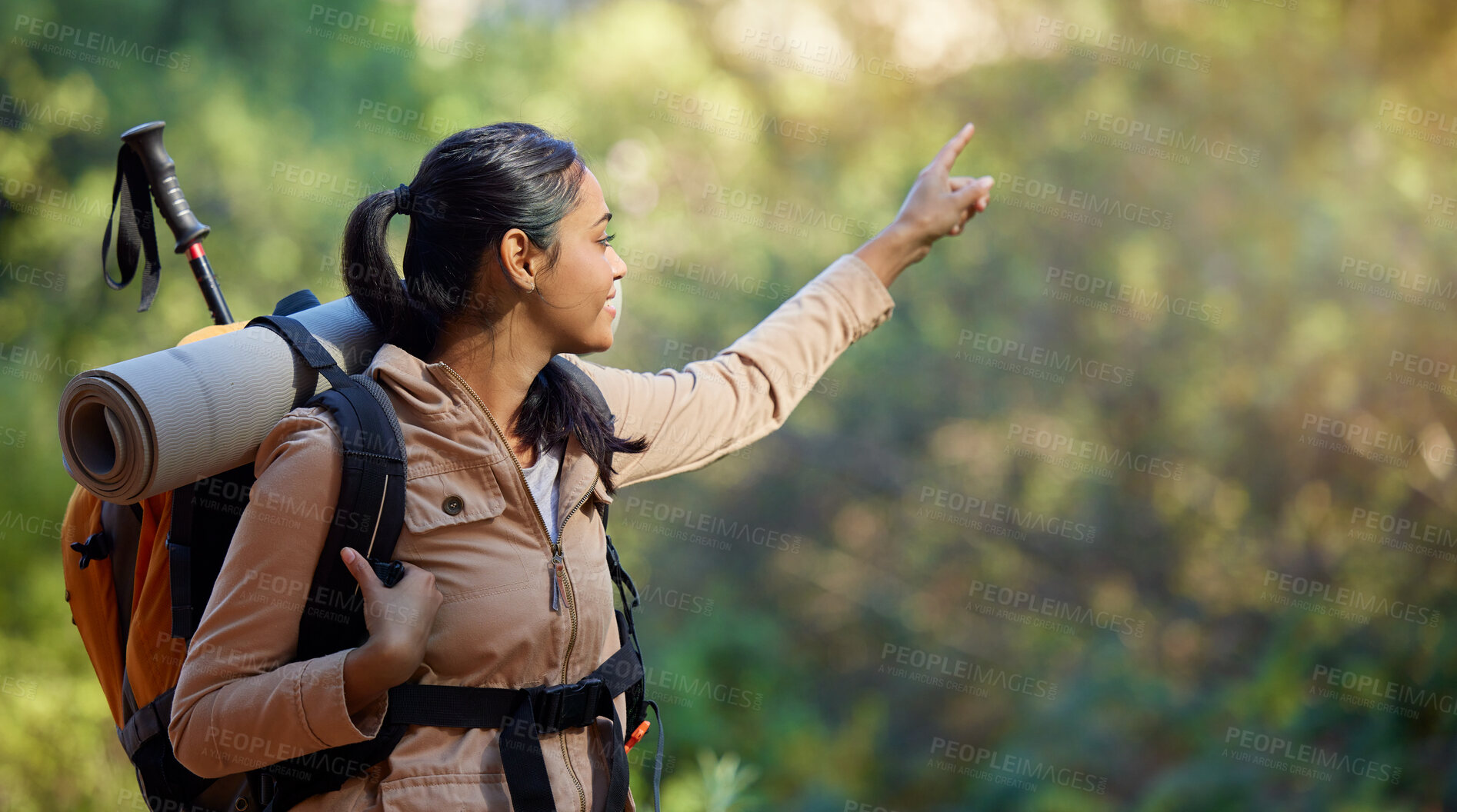 Buy stock photo Hiker, exercise and backpacking with a woman in nature for adventure and carefree freedom. Backpack, hiking and view with a female pointing while in a forest to hike while on a natural environment