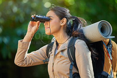 Buy stock photo Woman hiking, binocular and vision in forest with backpack, camping gear and smile on nature journey. Happy hiker girl, bird watching and trekking in woods for adventure, fitness and health in Amazon