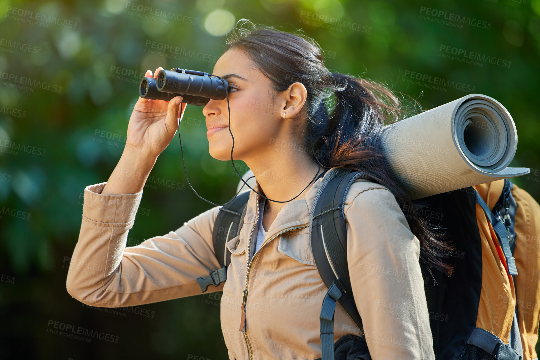 Buy stock photo Woman hiking, binocular and vision in forest with backpack, camping gear and smile on nature journey. Happy hiker girl, bird watching and trekking in woods for adventure, fitness and health in Amazon