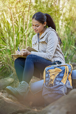 Buy stock photo Hiking, travel and woman writing in book sitting outdoors in nature. Freedom, hiker and happy female from India with personal diary, notebook or journal to write ideas, thoughts or journey experience