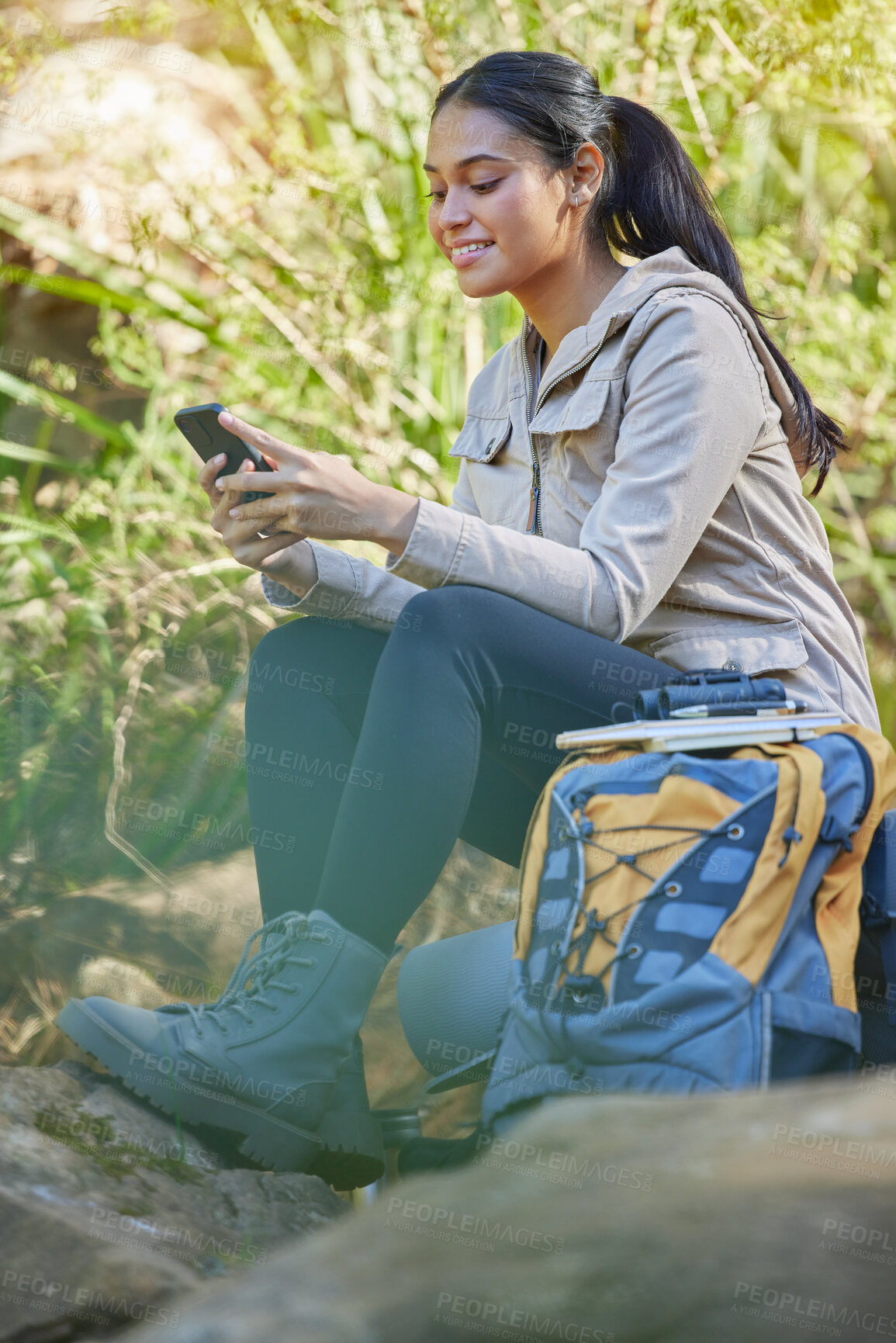 Buy stock photo Woman, hiking and phone in nature for communication, GPS location and navigation while outdoor in forest or woods with backpack. Female hiker happy about travel, adventure and mobile app for map