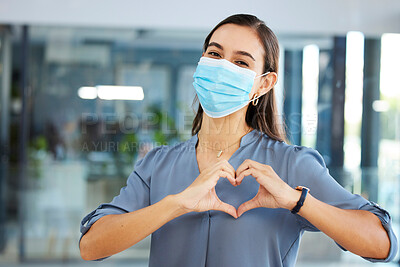 Buy stock photo Covid, employee or woman with heart sign or hand gesture in office building showing support, love or safety. Compliance, coronavirus or happy worker in face mask with peace, wellness or care at job