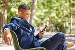 Phone, business man and typing at park, social media or internet browsing. Relax break, mobile tech and male employee sitting outdoors with 5g smartphone for networking, messaging or web scrolling.