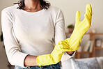 Cleaning, rubber gloves and hands of woman in living room for hygiene, protection and disinfection. Dirt, dust and bacteria with girl cleaner at home for sanitary, housekeeping and domestic chores