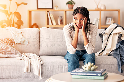 Buy stock photo Sad, thinking and black woman with depression on sofa in home. Mental health, anxiety and female from Nigeria on couch contemplating rent, student loans or life problems, mistake or stress in house.