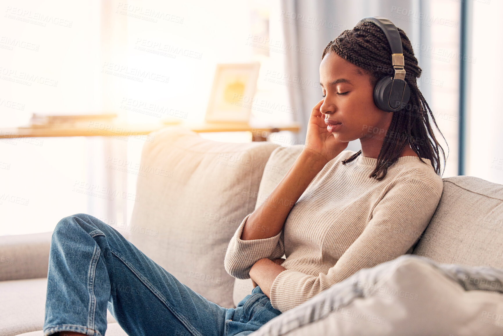 Buy stock photo Relax, music and black woman with calm podcast, wellness sound and tired with radio on the sofa. Zen, sleeping and girl with headphones listening to an audio for mindset and peace in the living room