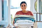 Portrait, cleaning or woman with laundry or happy smile after washing clothes or towels in cleaning services. Hospitality, hotel or face of Indian cleaner working at a airbnb, house or home in Mumbai