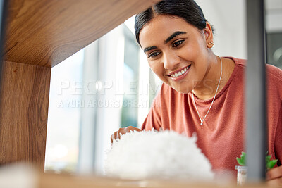 Buy stock photo Woman cleaner, duster and smile by wood, furniture or display in living room, home or hotel. House work, cleaning expert and happiness with shelf, dust and dirt with hospitality service in apartment