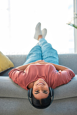 Buy stock photo Woman, sofa and upside down with headphones, smile or music in portrait to relax in lounge. Happy lady, couch or audio for happiness, streaming podcast or internet radio in home living room in Mexico