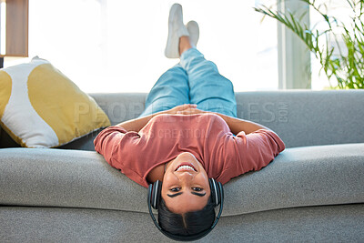 Buy stock photo Woman, sofa and relax with headphones, music and smile in portrait while upside down in lounge. Happy lady, couch and lying for happiness, streaming podcast or web radio in home living room in Mexico
