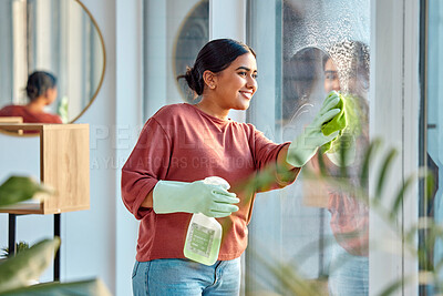 Buy stock photo Woman, cleaning and window st home for dirt, dust and bacteria with a cloth and spray bottle for shine and clean view. Happy female cleaner or maid with a smile using chemical on apartment glass