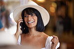 Happy woman, phone call and fashion with a hat while talking and having a conversation with smile on face for network connection. Female excited while speaking on smartphone while at mall on weekend